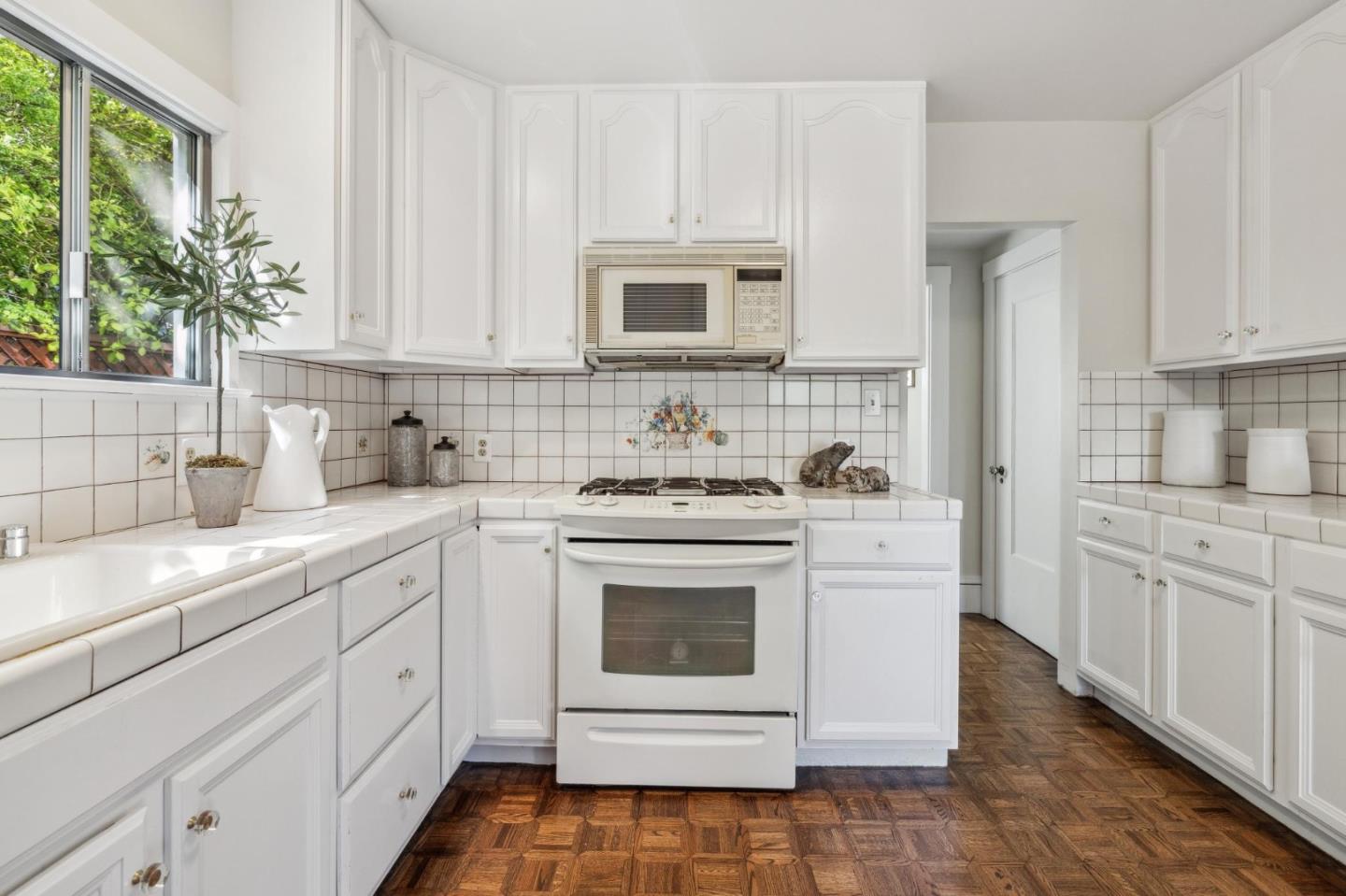 829 Edgehill Drive Burlingame, CA 94010 - Photo 25 of 99 a kitchen with white cabinets and white appliances