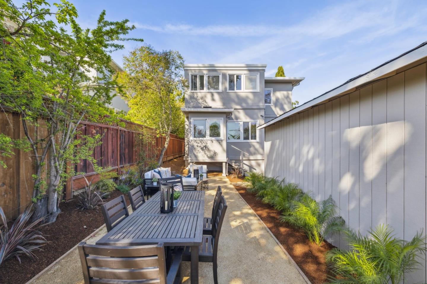 829 Edgehill Drive Burlingame, CA 94010 - Photo 69 of 99 a view of a patio with table and chairs potted plants and wooden fence