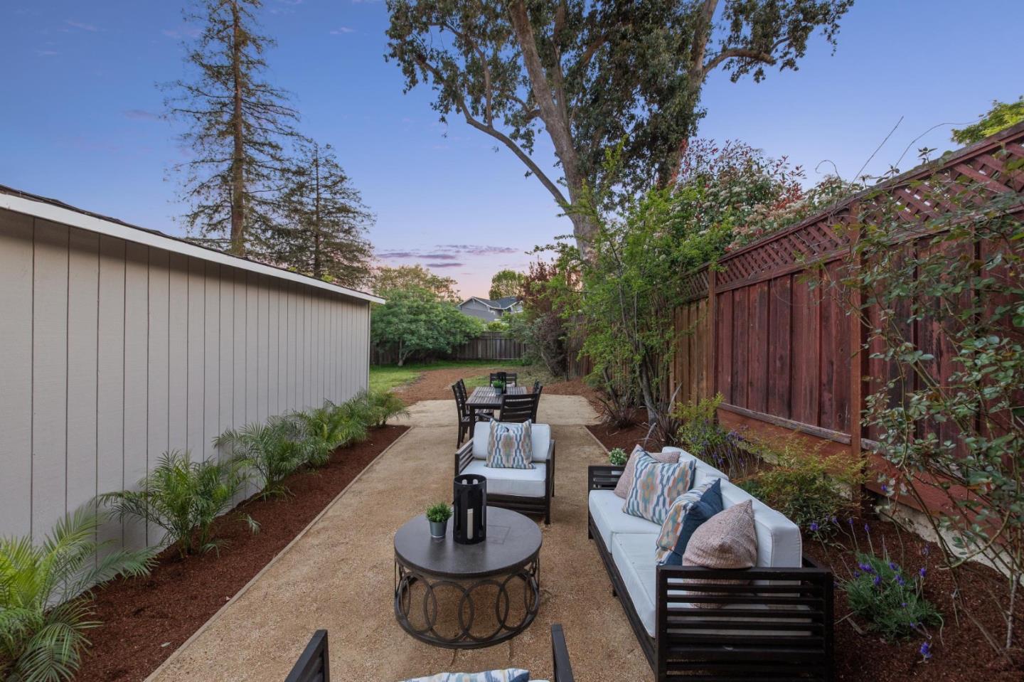 829 Edgehill Drive Burlingame, CA 94010 - Photo 86 of 99 a view of a patio with couches table and chairs with plants and wooden fence