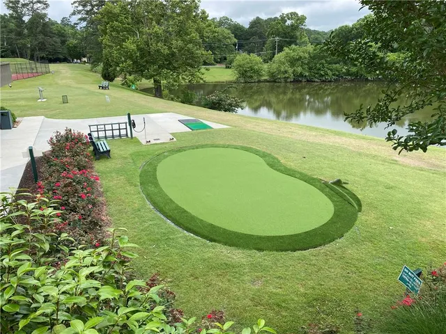 a view of a swimming pool with a garden and trees