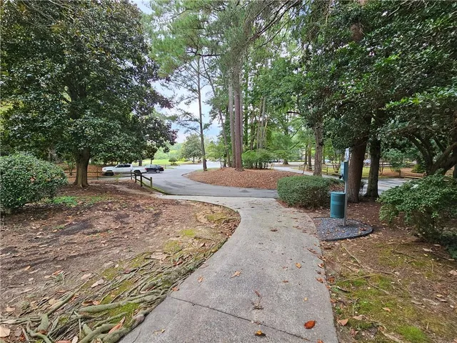 a view of a backyard with large trees