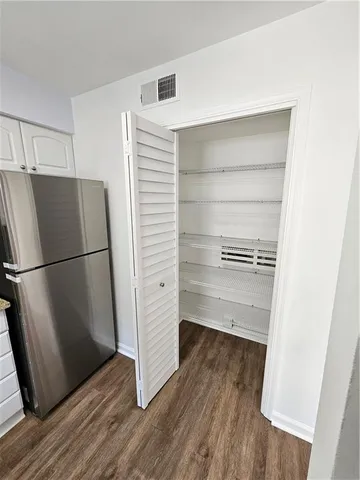 a view of walk in closet with empty racks