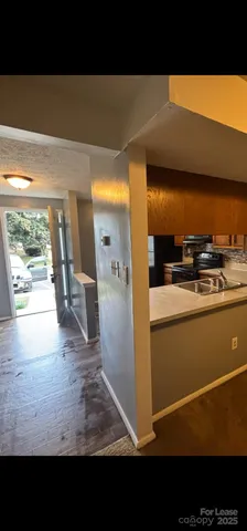 a view of open kitchen with wooden floor