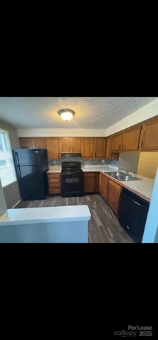 a view of storage and utility room with wooden floor