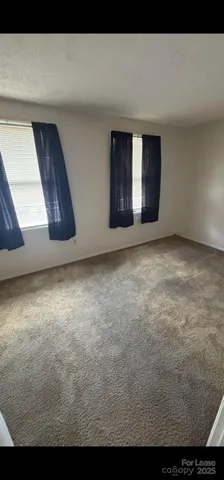 a view of an empty room with closet
