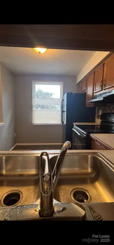 a kitchen with a sink and a stove