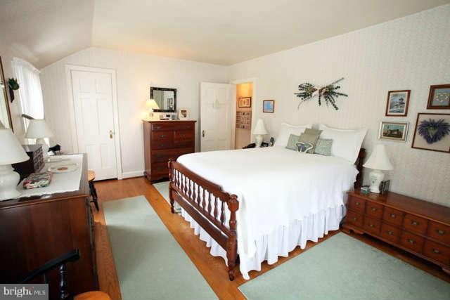 302 Worthington Road Baltimore, MD 21286 - Photo 13 of 24 a bedroom with a bed and a flat tv screen on the dresser