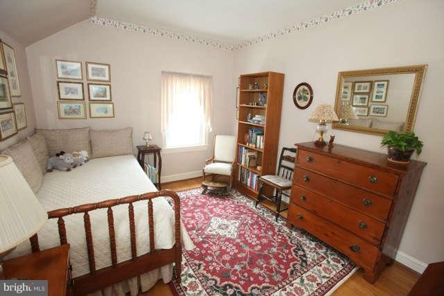 302 Worthington Road Baltimore, MD 21286 - Photo 16 of 24 a bedroom with a bed and wooden floor