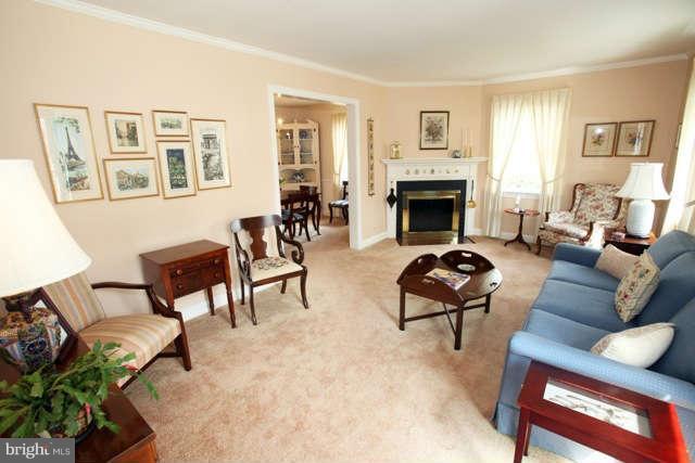 302 Worthington Road Baltimore, MD 21286 - Photo 3 of 24 a living room with furniture two windows and a fireplace