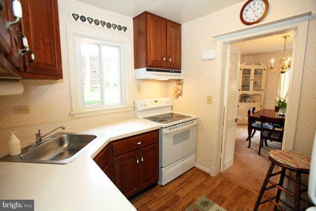 302 Worthington Road Baltimore, MD 21286 - Photo 5 of 24 a kitchen with a sink cabinets and window