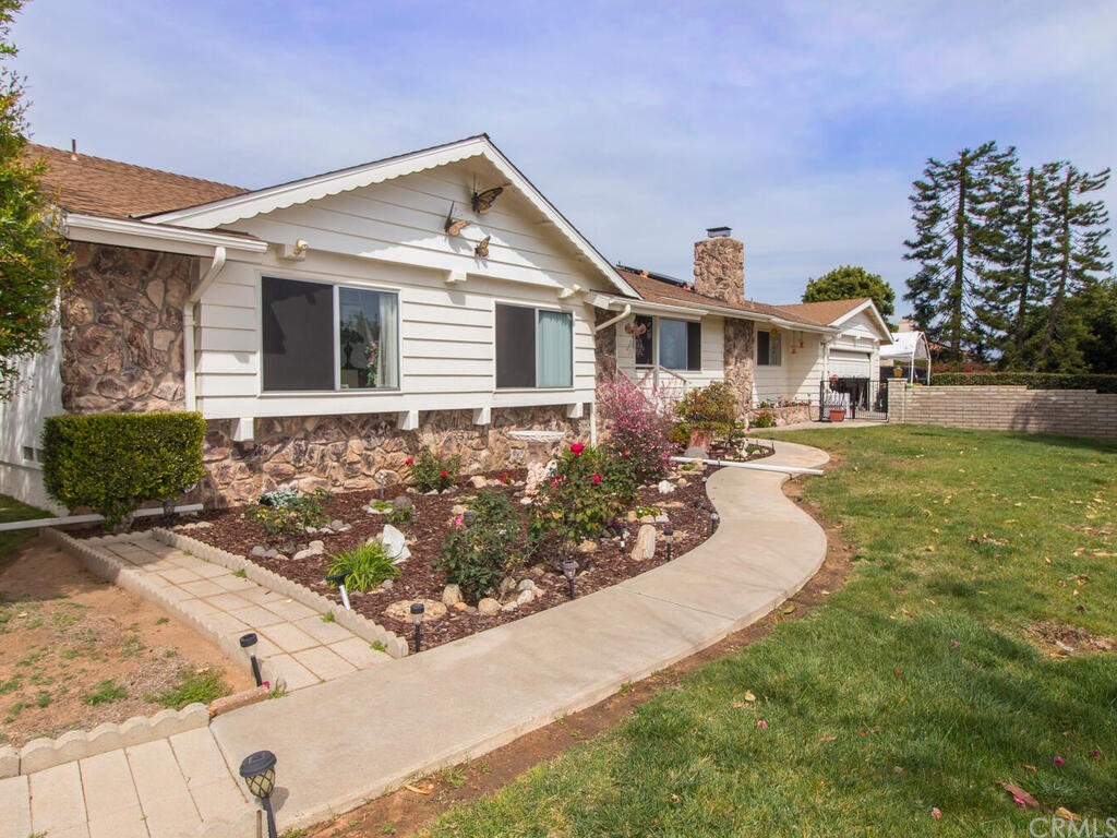 a front view of a house with garden