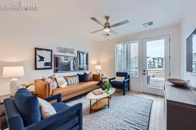 a living room with furniture and wooden floor