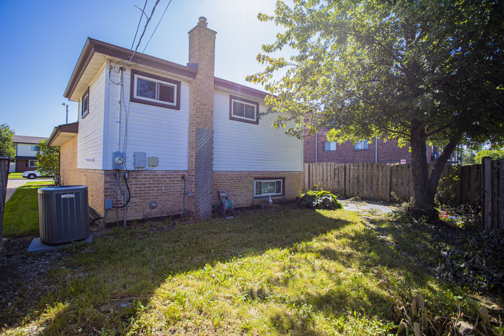 11040 Massasoit Avenue Chicago Ridge, IL 60415 - Photo 22 of 23 a backyard of a house with wooden fence and a tree