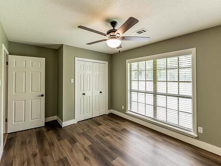 50 Neiderhoffer Subdivision Road Huntsville, TX 77340 - Photo 11 of 20 wooden floor in an empty room with a window