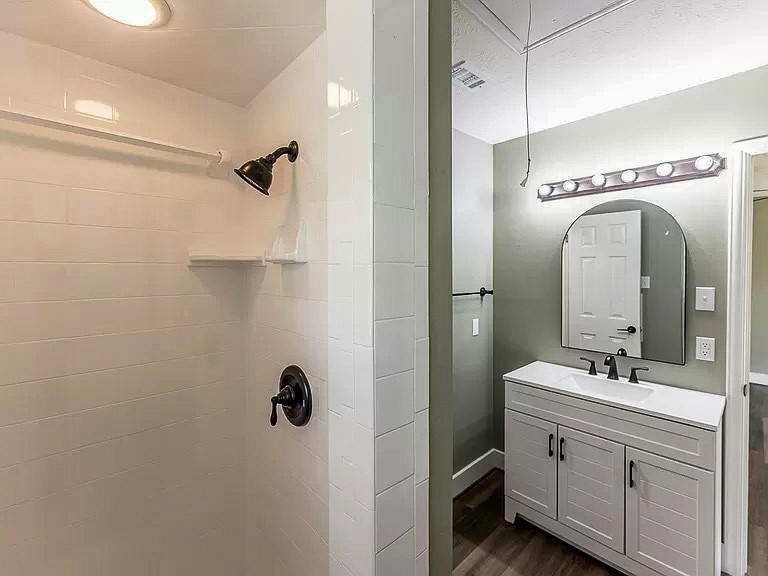 50 Neiderhoffer Subdivision Road Huntsville, TX 77340 - Photo 15 of 20 a bathroom with a double vanity sink a mirror and shower