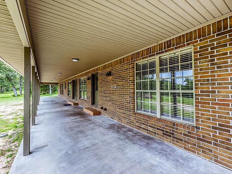 50 Neiderhoffer Subdivision Road Huntsville, TX 77340 - Photo 17 of 20 a view of a house with a backyard