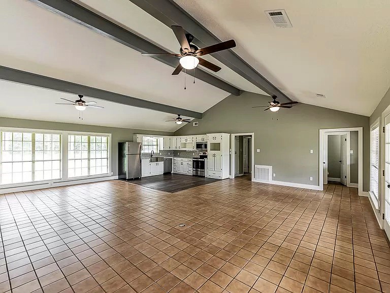 50 Neiderhoffer Subdivision Road Huntsville, TX 77340 - Photo 6 of 20 a view of empty room with wooden floor and fan