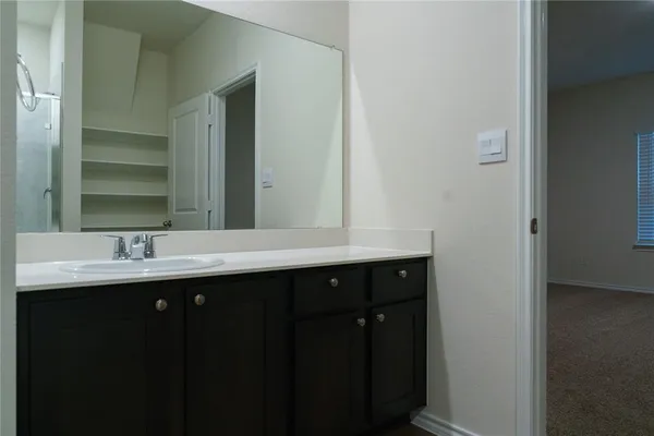 a bathroom with a double vanity sink and mirror