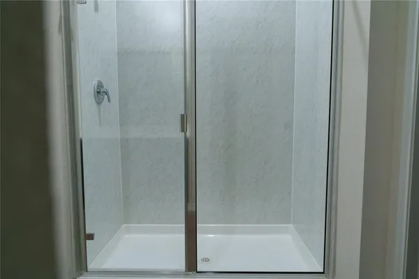 a bathroom with a glass shower door