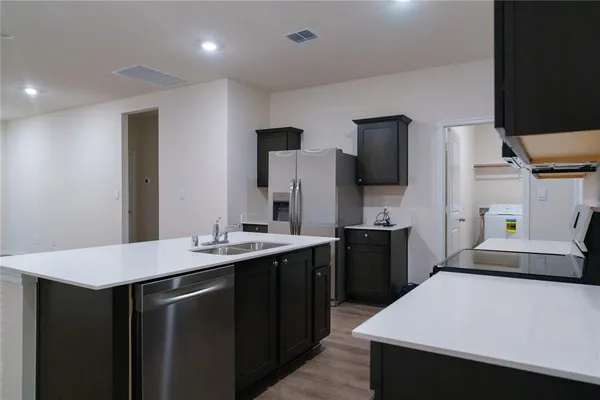 a kitchen with a sink and refrigerator