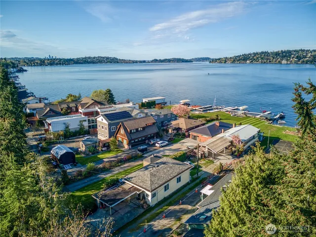 a aerial view of a house with outdoor seating and lake view