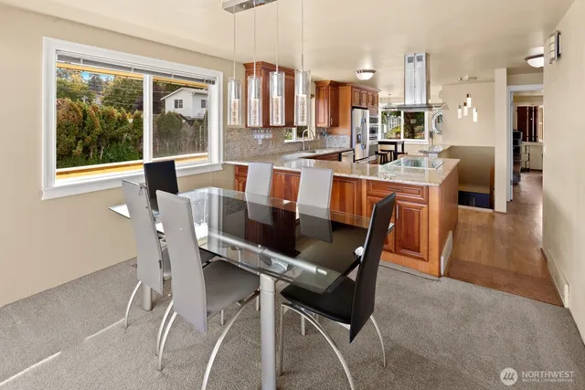 a kitchen with stainless steel appliances granite countertop a refrigerator and a stove top oven