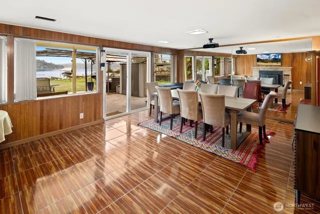 a kitchen with stainless steel appliances granite countertop a refrigerator a sink dishwasher a stove with wooden floor and cabinets