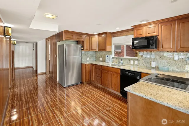 a bathroom with a granite countertop sink mirror and toilet