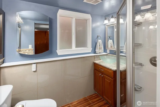 a bathroom with a sink toilet and mirror