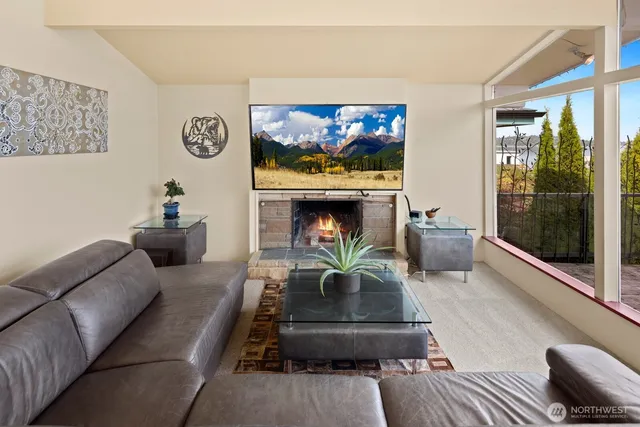a view of a dining room with furniture large windows and wooden floor