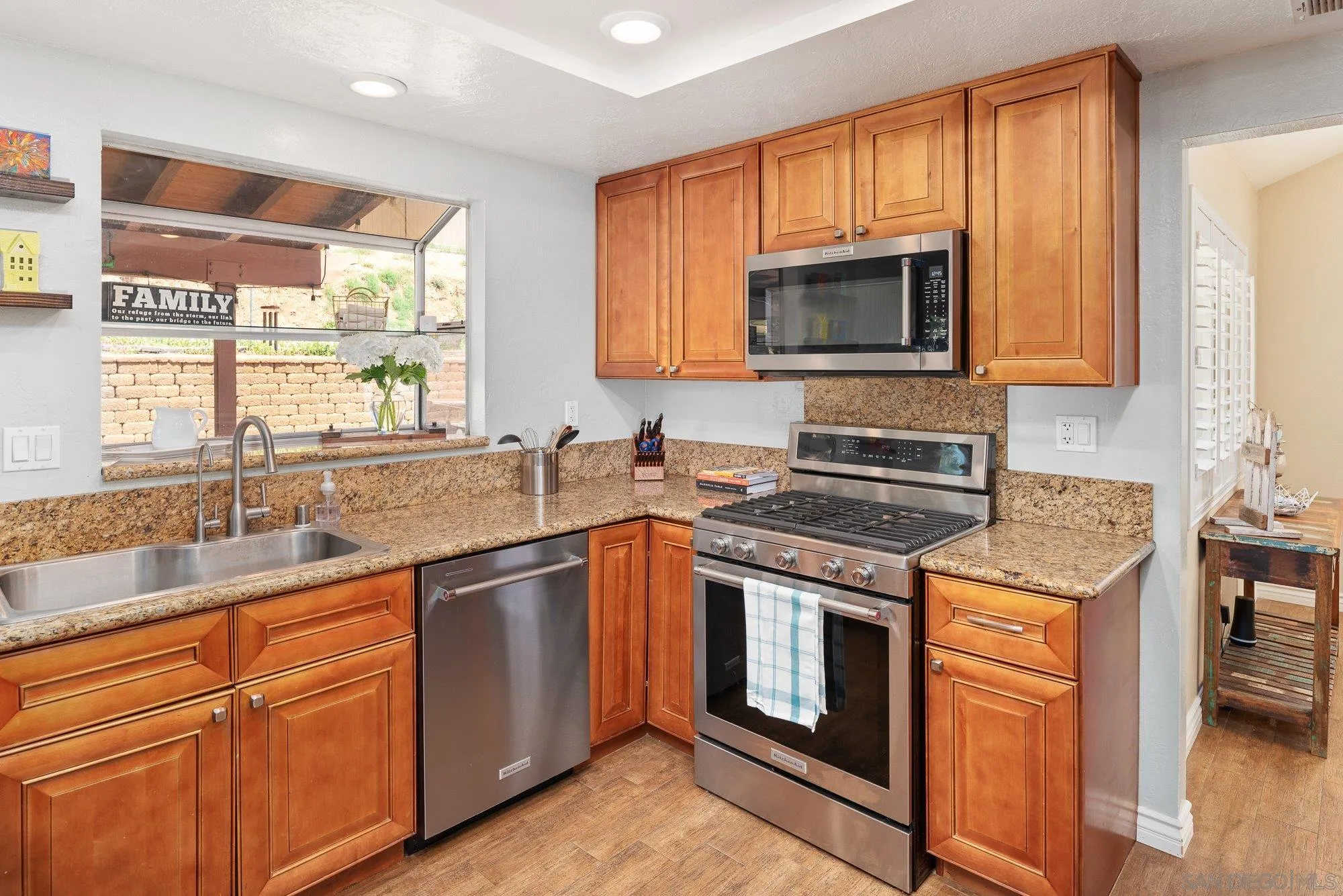 10246 Princess Joann Road Santee, CA 92071 - Photo 14 of 48 a kitchen with stainless steel appliances granite countertop a sink stove and microwave