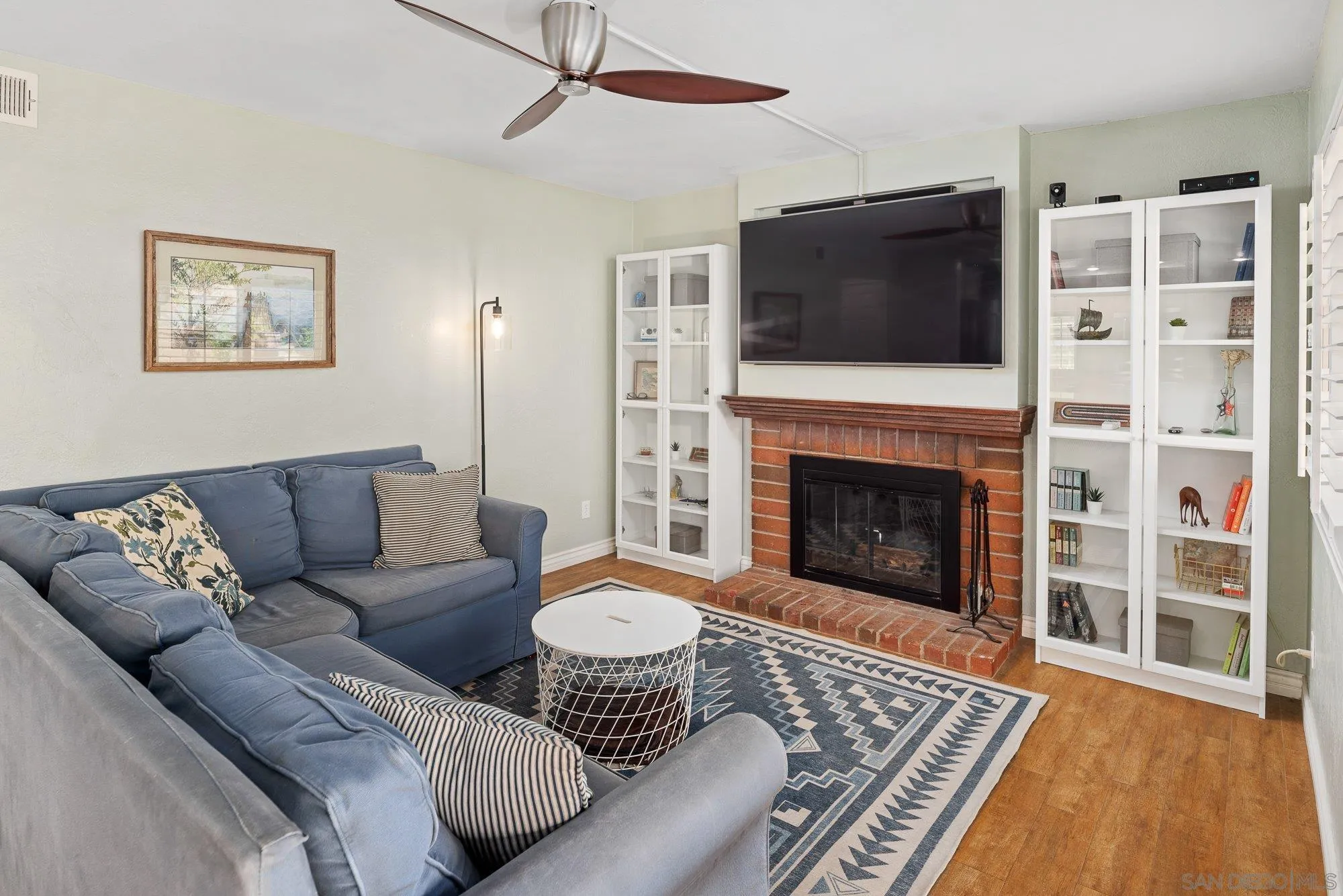 10246 Princess Joann Road Santee, CA 92071 - Photo 19 of 48 a living room with furniture a flat screen tv and a fireplace