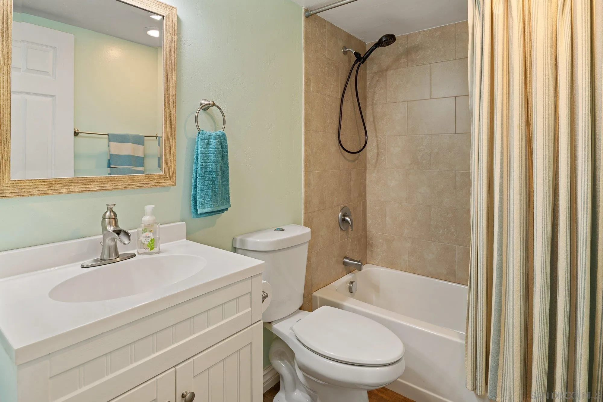 10246 Princess Joann Road Santee, CA 92071 - Photo 22 of 48 a bathroom with a sink toilet vanity and shower
