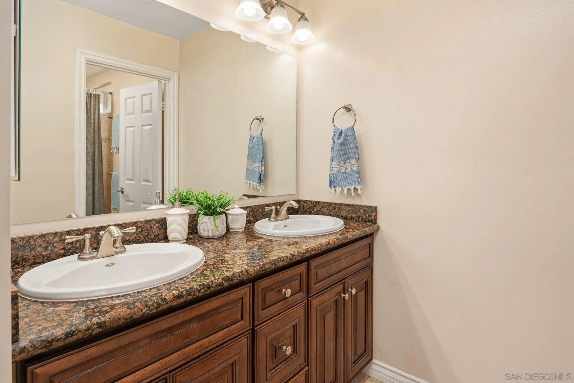 10246 Princess Joann Road Santee, CA 92071 - Photo 25 of 48 a bathroom with a granite countertop sink and a mirror