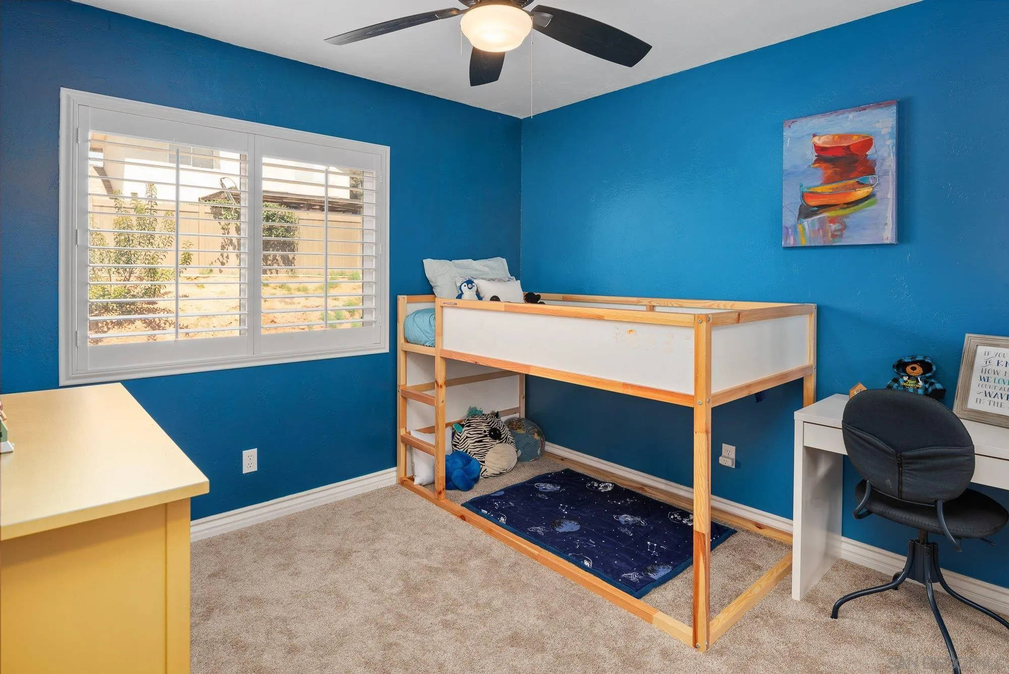 10246 Princess Joann Road Santee, CA 92071 - Photo 27 of 48 a bedroom with a bed and a chandelier