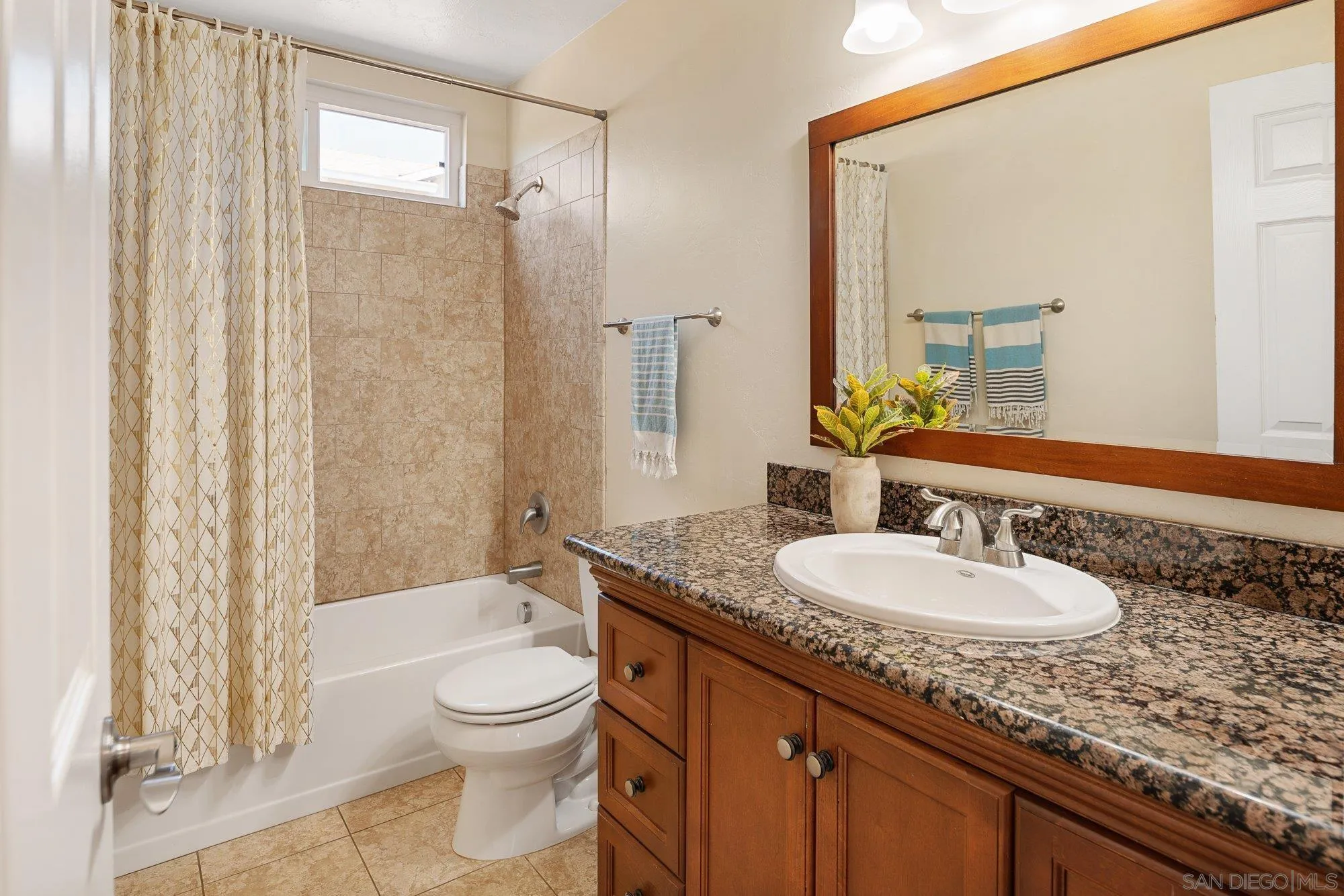 10246 Princess Joann Road Santee, CA 92071 - Photo 28 of 48 a bathroom with a granite countertop sink toilet a large mirror and shower