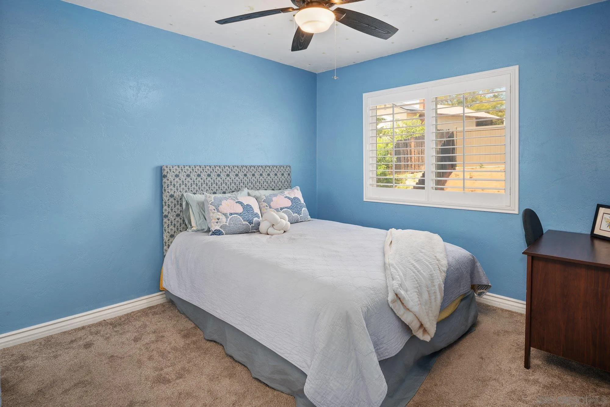 10246 Princess Joann Road Santee, CA 92071 - Photo 29 of 48 a bedroom with a bed and a chandelier