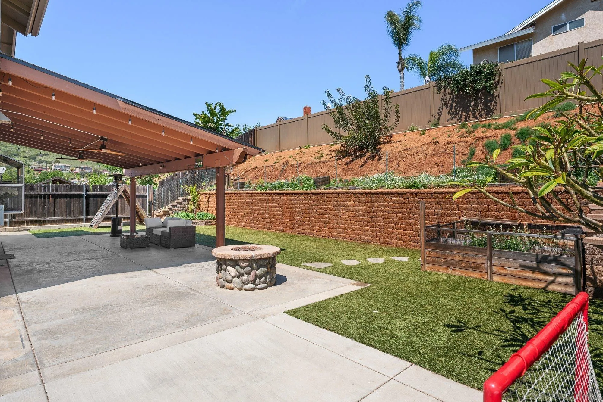 10246 Princess Joann Road Santee, CA 92071 - Photo 30 of 48 a view of a patio with table and chairs potted plants