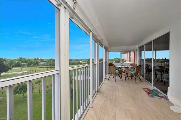 a view of a chairs and table in a balcony