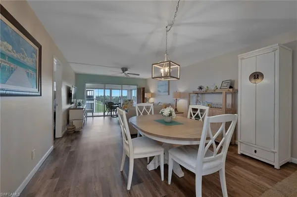 a view of a dining room with furniture wooden floor and chandelier
