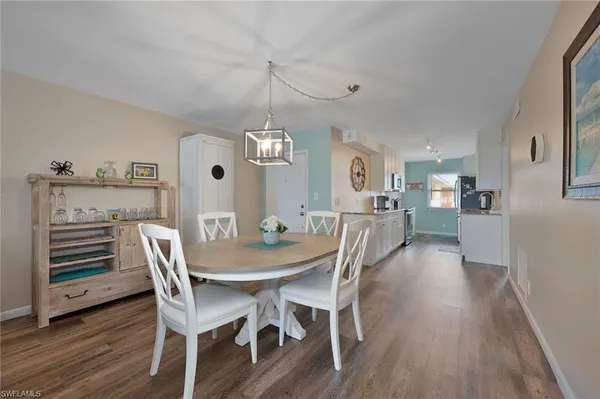 a view of a dining room with furniture wooden floor and chandelier