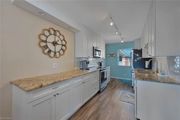 a large kitchen with a stove and a sink