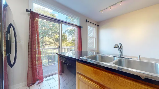 a kitchen with a sink and a large window