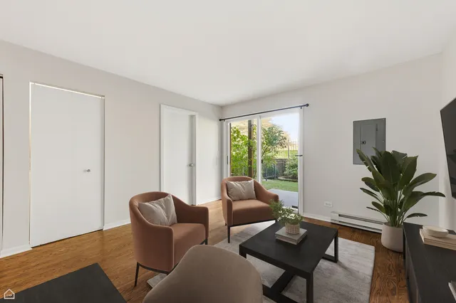 a living room with furniture potted plant and a window