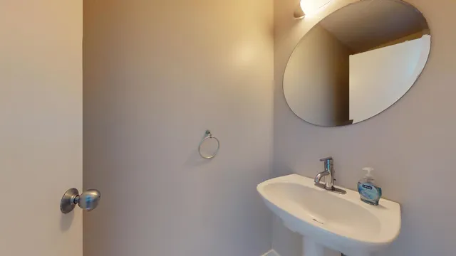 a bathroom with a sink and mirror