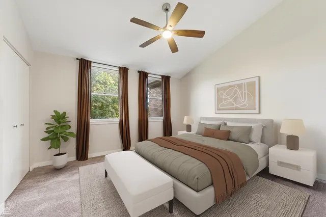 a bedroom with a large bed and a large window