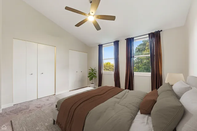 a bedroom with a large bed and a large window