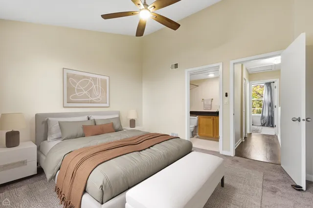 a bedroom with a bed and a chandelier