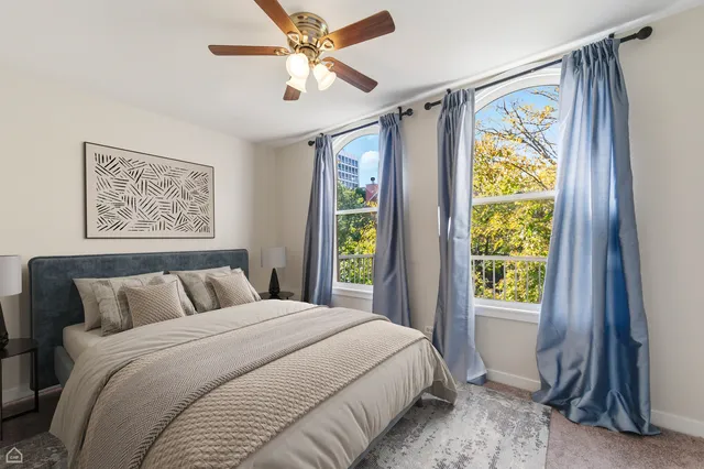 a bedroom with a bed and a window