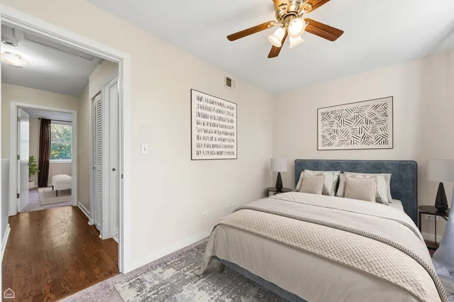 a bedroom with a large bed and a chandelier